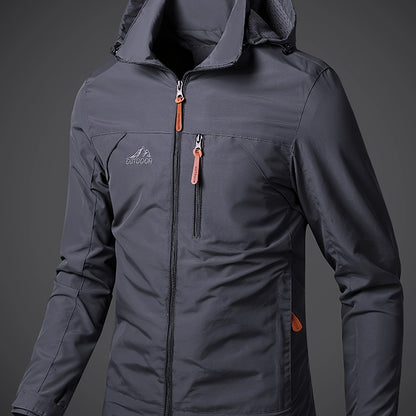 Men's lightweight hooded polyamide jacket with zipper closure and polyester lining, ideal for hiking and outdoor activities in the spring/fall season.