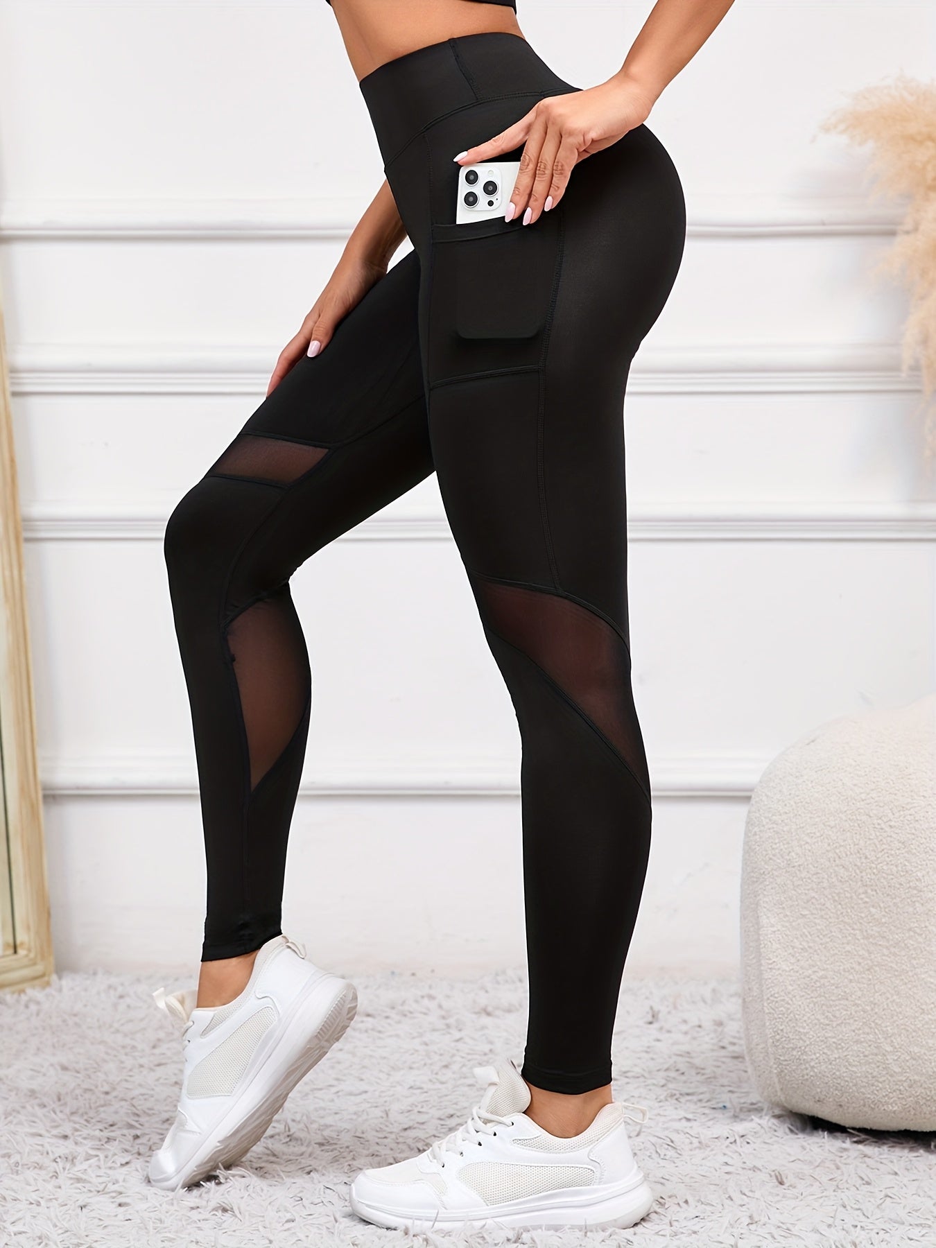 High-waist yoga leggings with pocket, comfy stretch fit, sleek black with mesh panels, perfect for everyday and workouts.