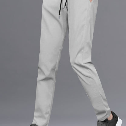 Stylish men's solid pants with pockets, casual and breathable drawstring trousers for outdoor activities.