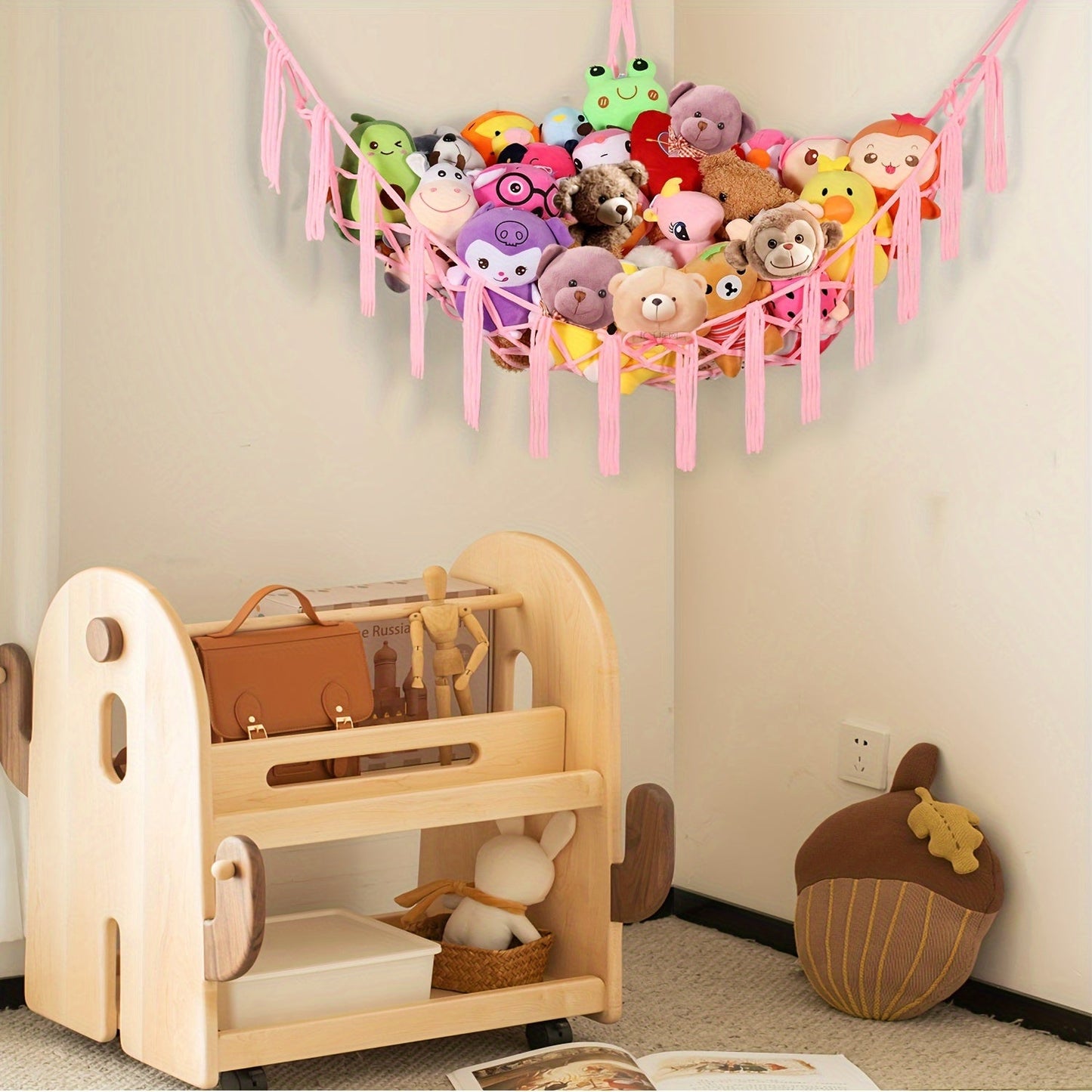 Large Boho-style net hammock for storing and hanging pink stuffed animals. Perfect for keeping your favorite toys organized and displayed in a fun and stylish way.