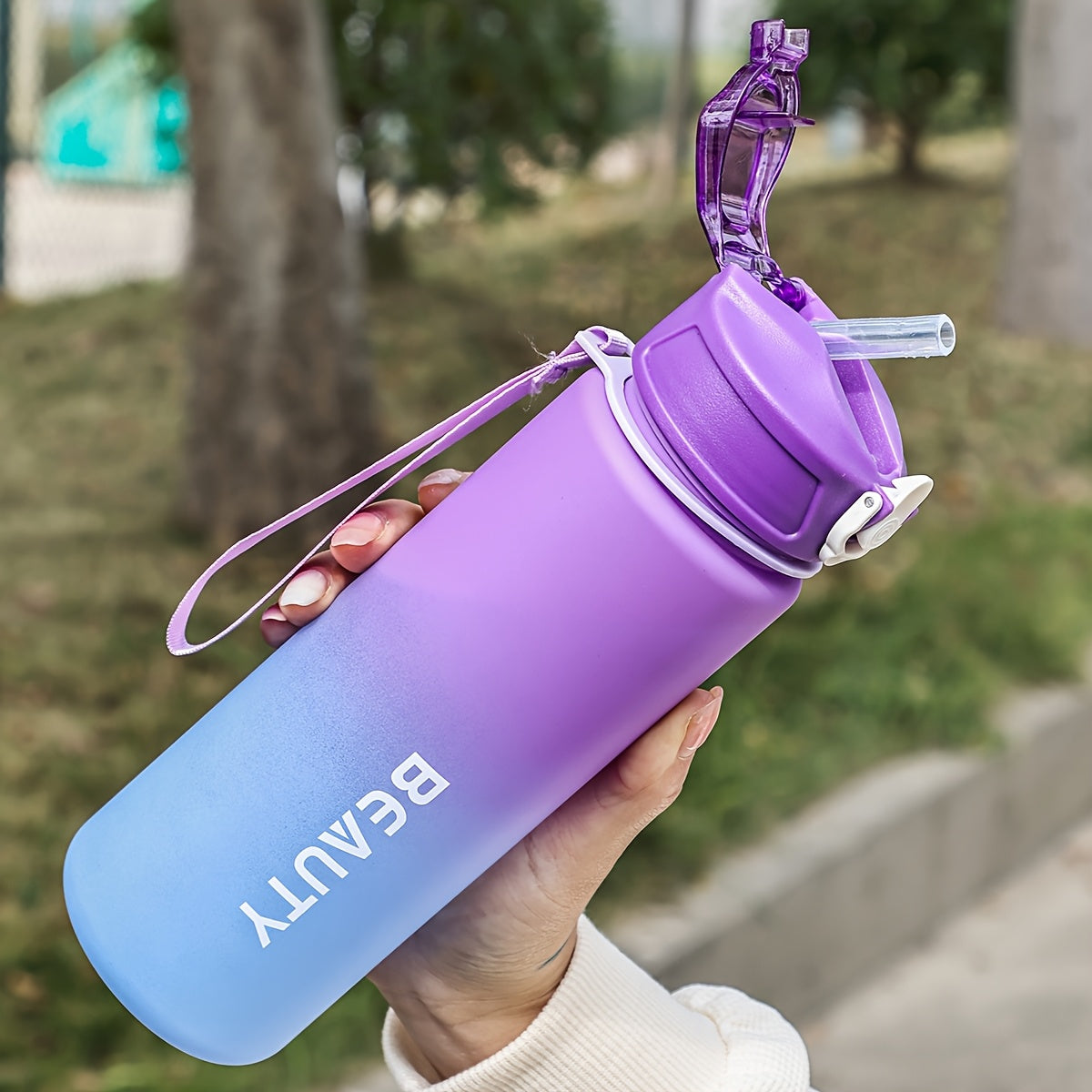 Durable, lightweight, and portable frosted plastic water bottle with scale for outdoor sports and office use.