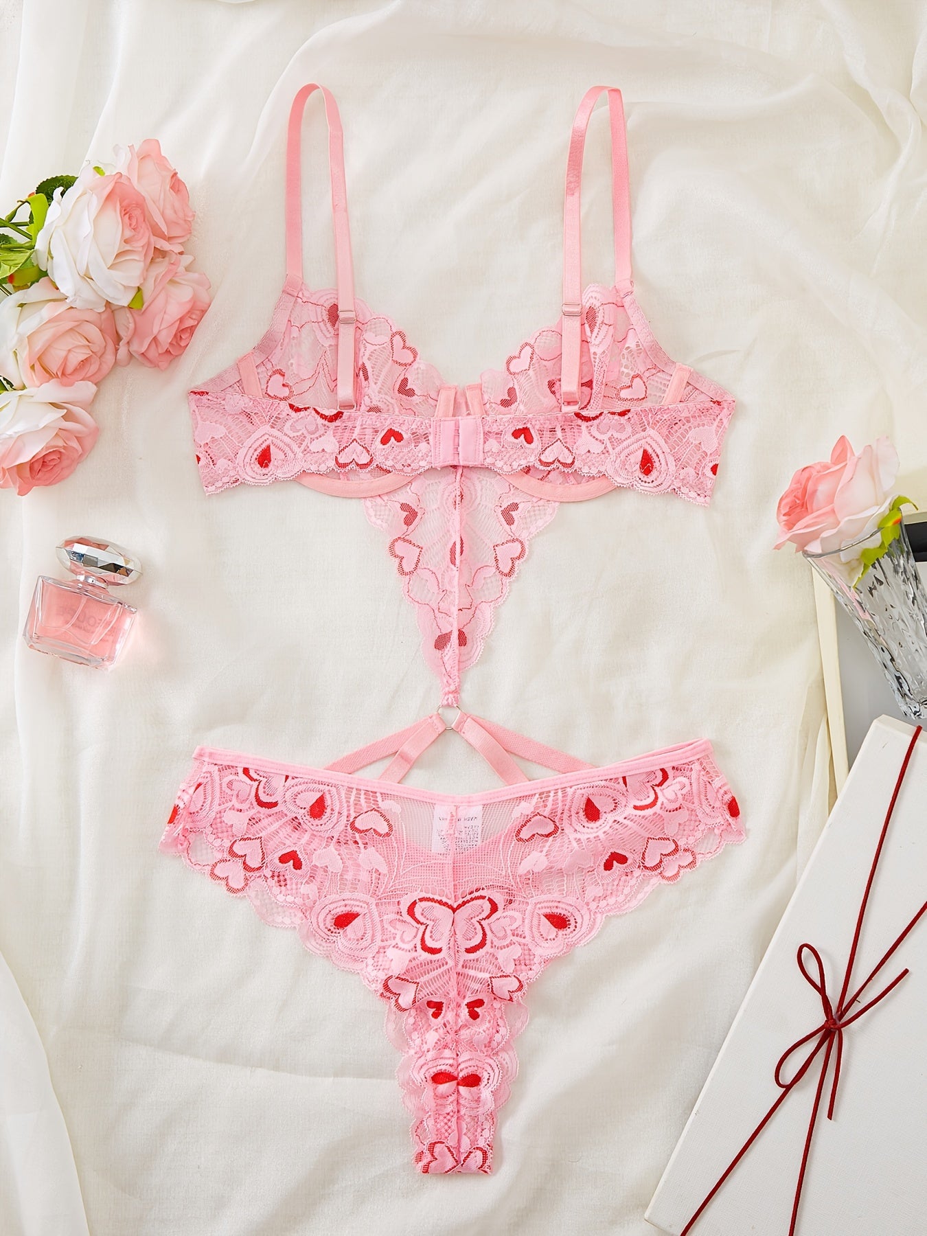 Pink heart-embroidered adult lingerie set made from polyamide and elastane blend, suitable for adults.