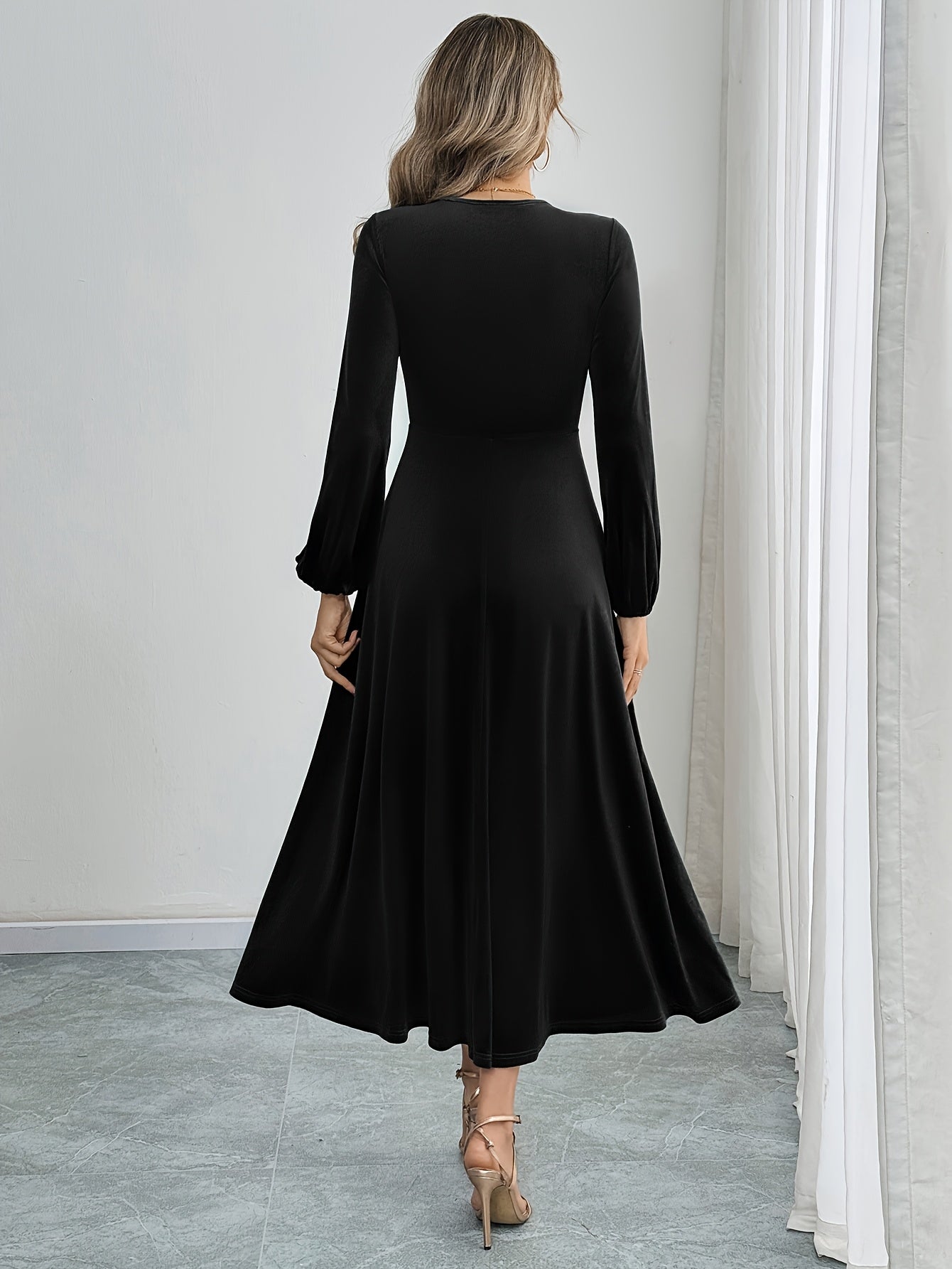 Black velvet A-line dress with flared sleeves, crew neck, and long sleeve made of polyester knit for all-season wear. Ideal for adult women's fashion as elegant attire.