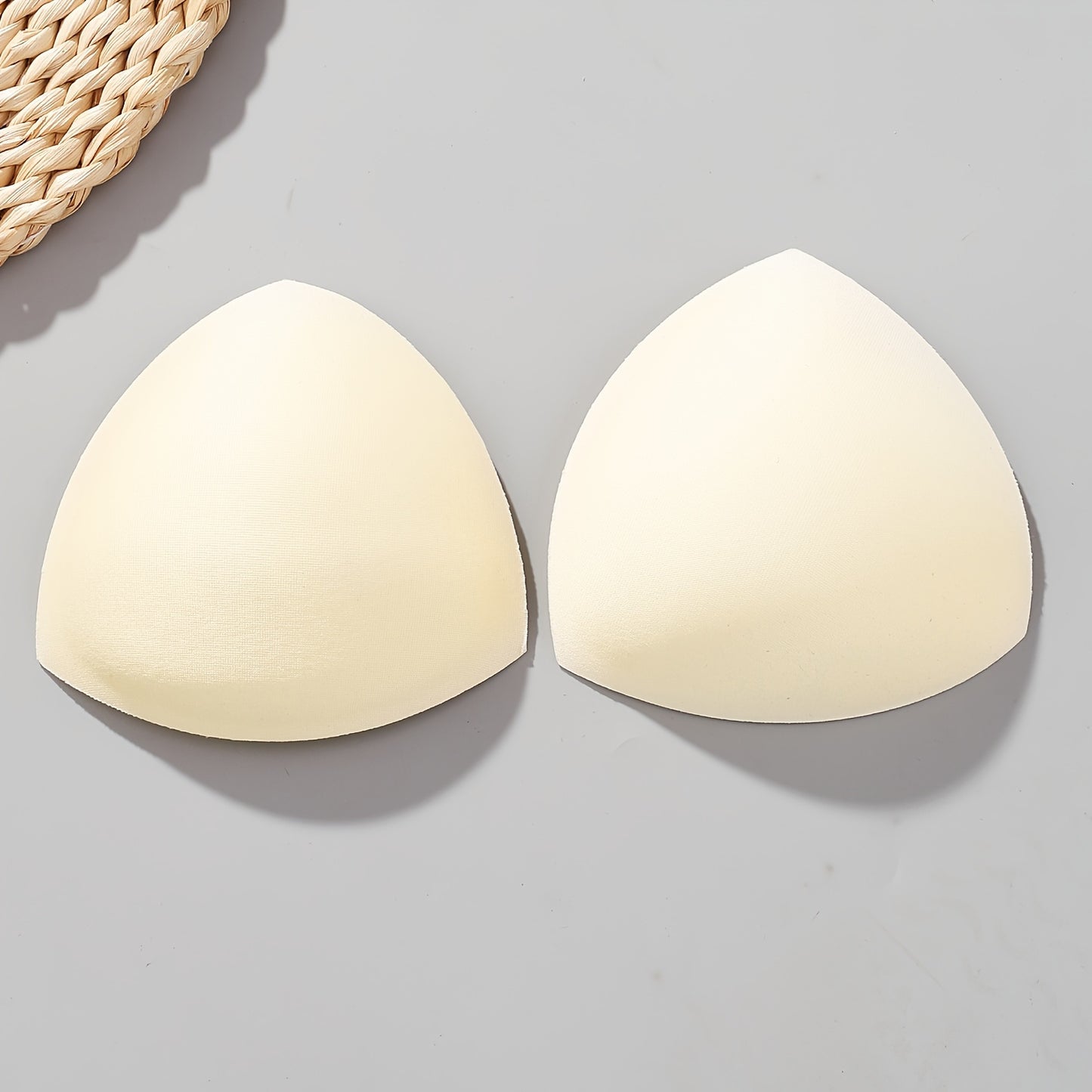 Women's triangle bra pads enhance and lift with push-up and adjustable features. Available in black, white, and nude colors.