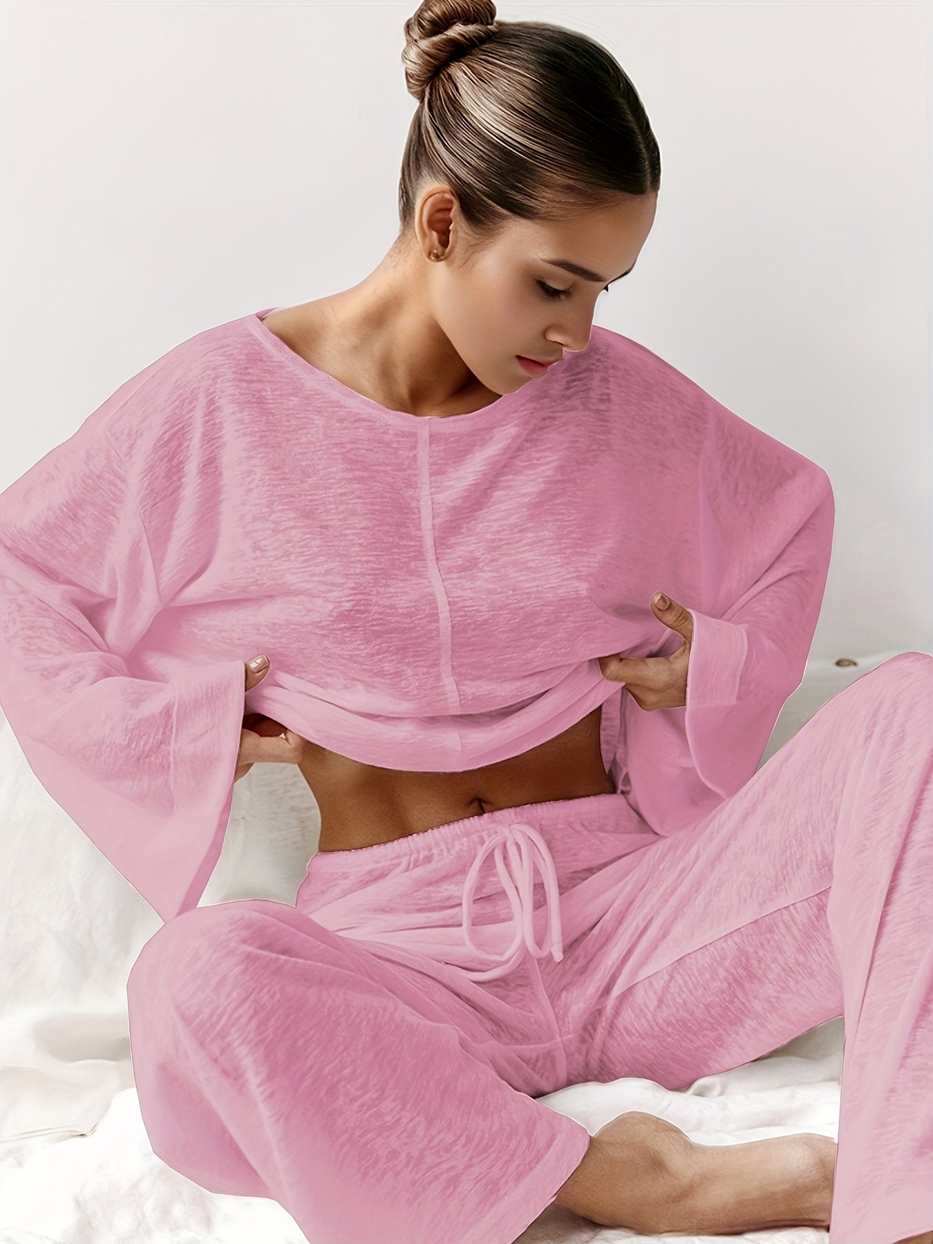 Two-piece set of loose home clothes for women made with micro-transparent fabric featuring a round neck, long sleeves, and trousers.