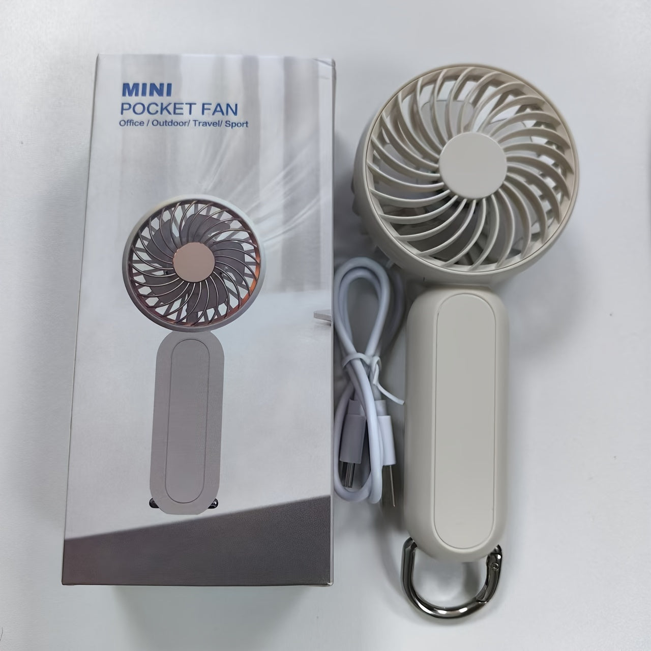 This mini portable fan is perfect for those on the go. It is handheld, personal, USB rechargeable, and battery-operated. You can bring it to the office, bedroom, outdoor travel, and camping. It also comes with a hook loop for easy carrying and