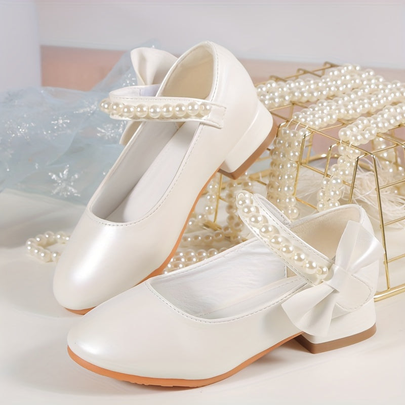 Princess high heels for girls with pearl accents and bowknot. Breathable and non-slip, perfect for school, parties, and formal events. White synthetic material with chunky heel and round