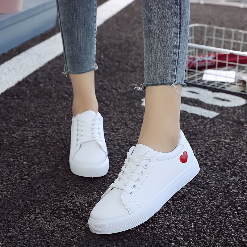 Stylish women's casual sneakers with heart-shaped design, lace-up style, and flat white soles - ideal for leisure wear.