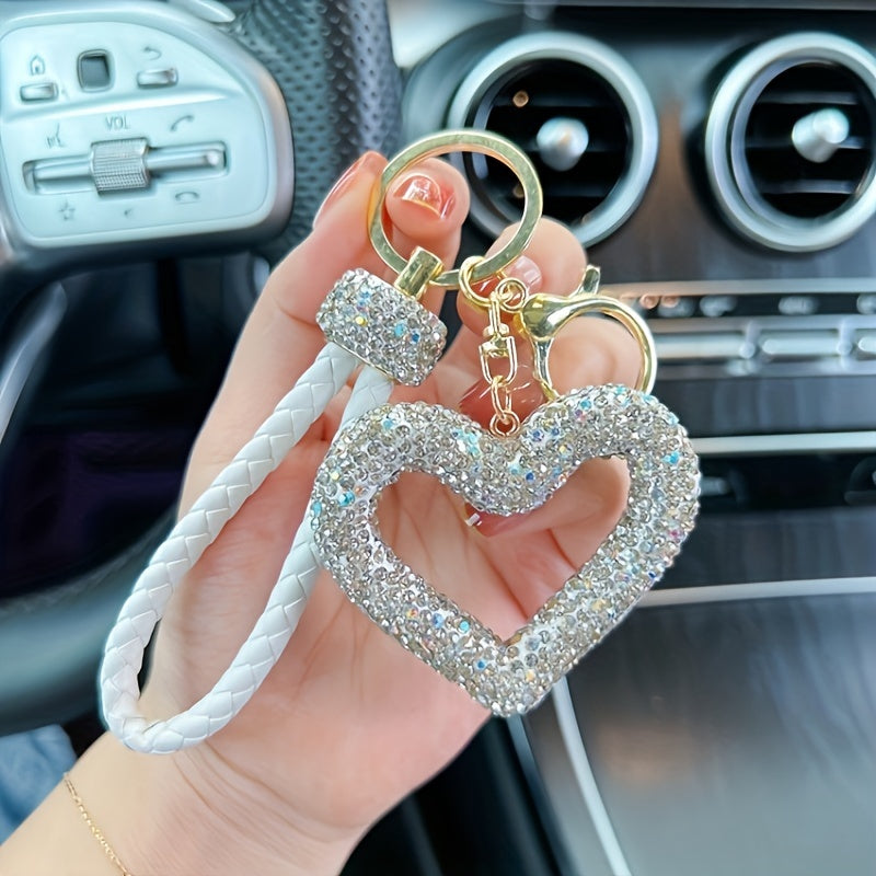 Heart-shaped resin keychain adorned with sparkling rhinestones, featuring a fun cartoon design for a touch of whimsy. Complete with a lobster clasp for easy attachment, this unique keyring is perfect for adding a festive touch to your holiday decor.