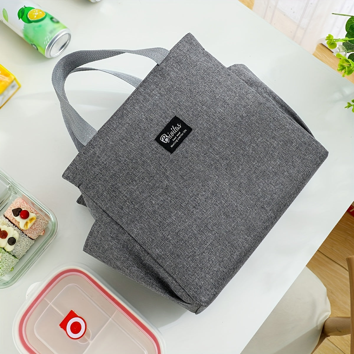 Travel in style with the Oxford Fabric Lunch Bag, a durable and insulated food container that has been thickened and expanded for extra space. This portable rectangular bento box features convenient side pockets for storing utensils or napkins. The sleek