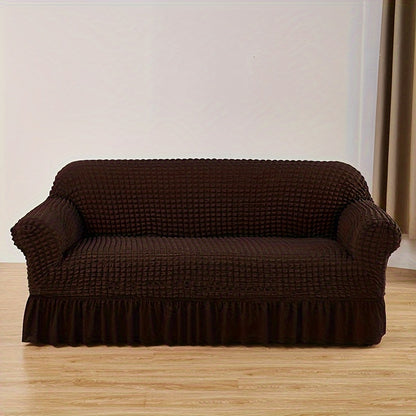 Seersucker skirt sofa cover protects couch from cat scratches in bedroom, office, or living room.