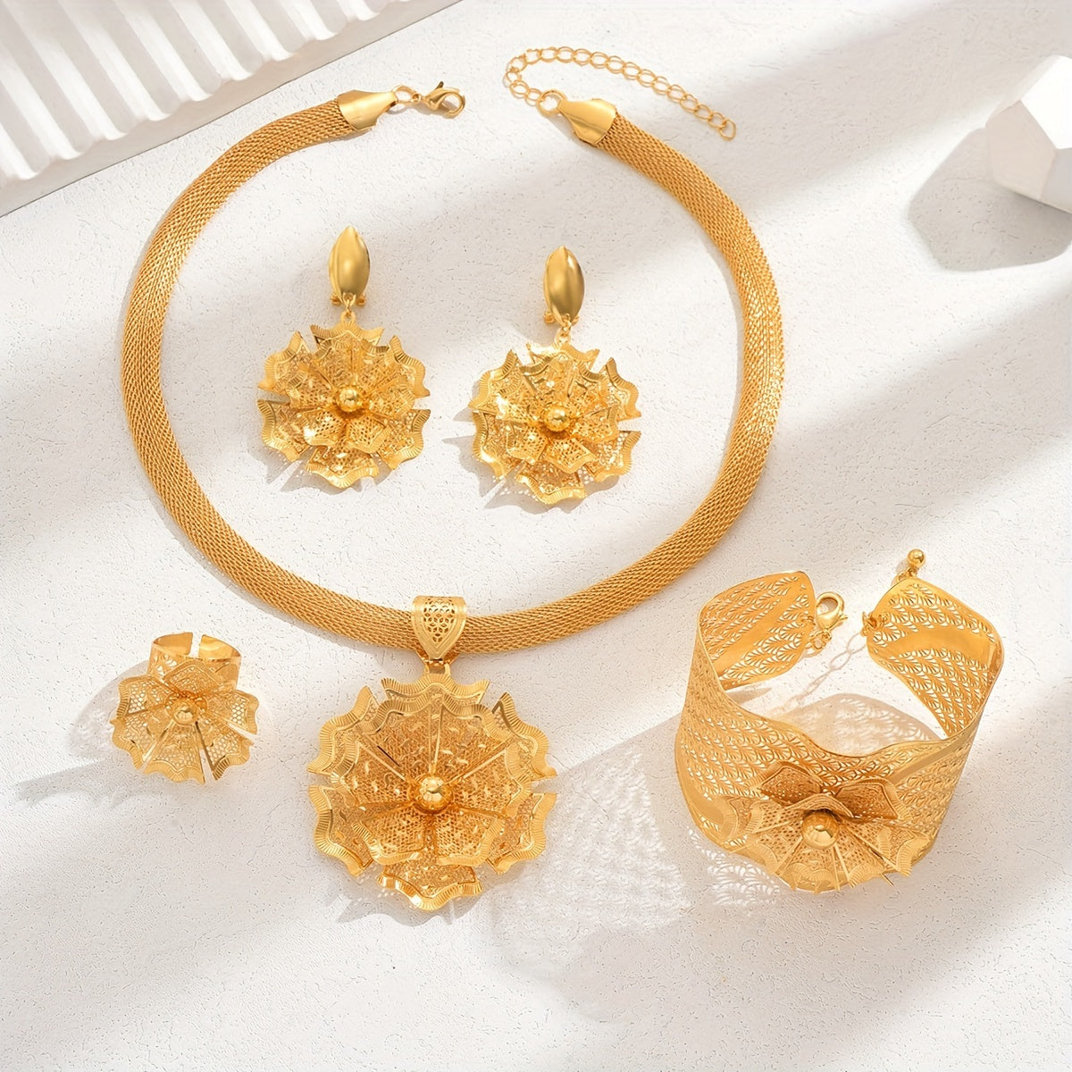 Luxurious five-piece bridal wedding accessories set featuring intricate flowers, stunning bracelets, rings, earrings, pendants, and necklaces in a bold ethnic design. This golden jewelry set is perfect for special occasions like banquets and vacations.