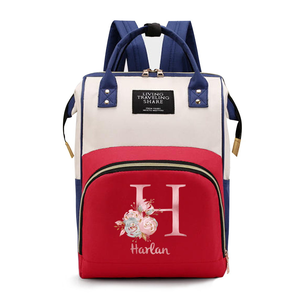 Personalized Mommy Backpack made of durable Oxford cloth with ample storage space for diapers and other essentials. Features customizable initials and name, as well as convenient bottle pockets. Perfect for nursing mothers on-the-go, with options for A-Z