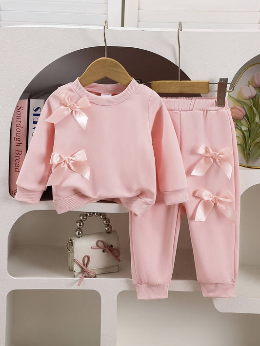 Baby girls' pink sweatshirt and pants set with double bows, ideal for outdoor wear in spring and autumn.