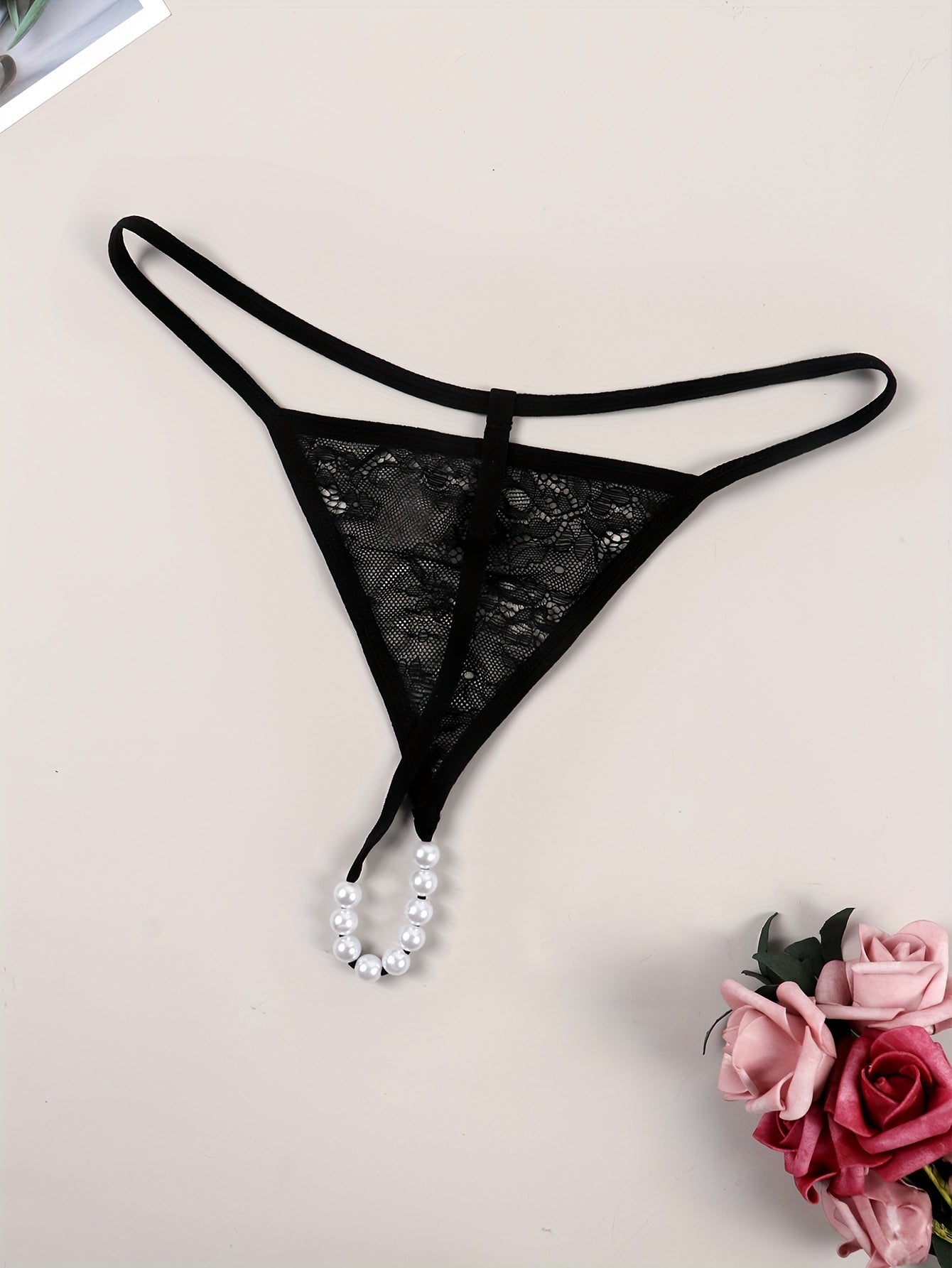 Sexy lace thong embellished with beads, transparent design for women.