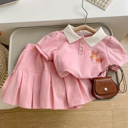 Pink floral short-sleeve collared top and pleated skirt set for charming girls, made from cotton blend fabric, ideal for casual wear in summer.