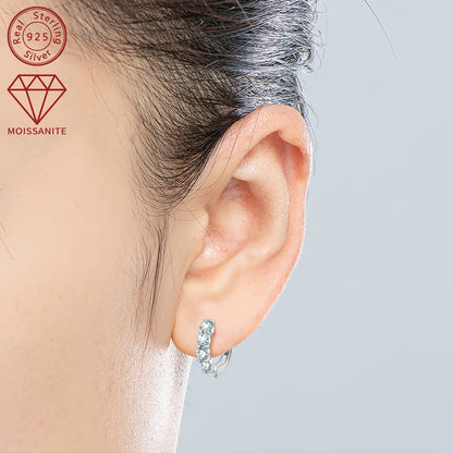 These women's fashion earrings feature a classic daily style, crafted with 925 silver and set with 10 pieces of 3.5mm moissanite stones, each weighing 1.0ct. The total weight of the earrings is 3.39g. These round synthetic moissanite earrings are a