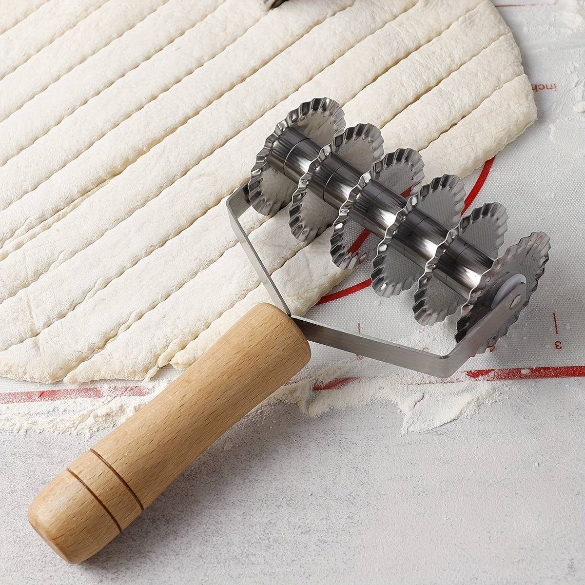 Six-wheel stainless steel cookie and noodle cutter with a wavy wood handle - Perfect for cutting cookies and noodles in the kitchen.