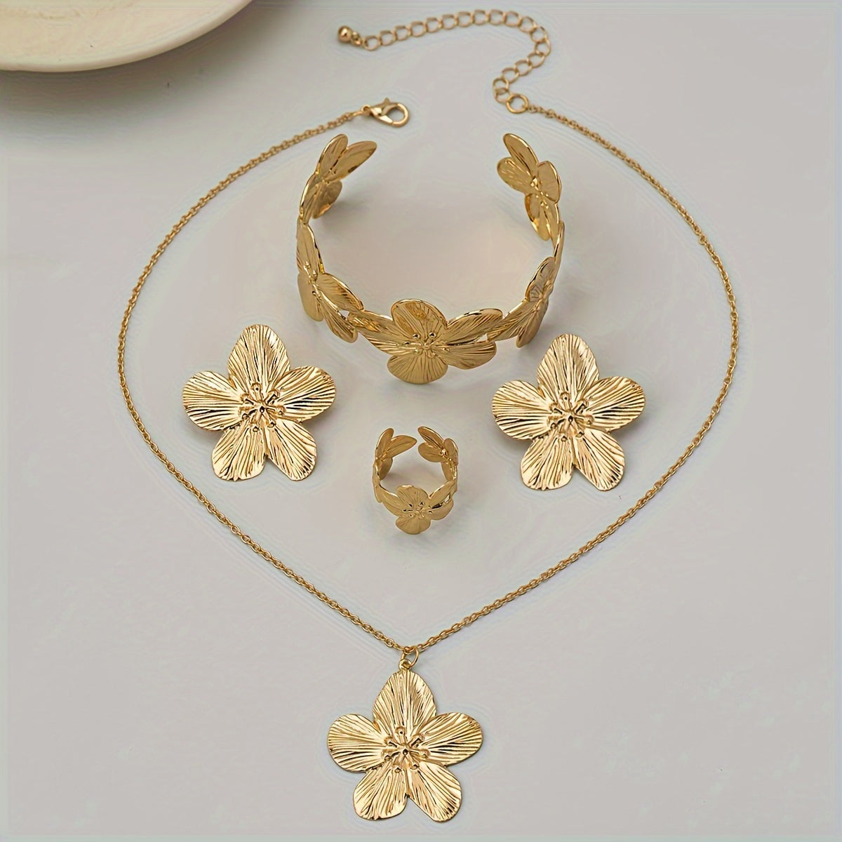 Set of 5 stylish and beautiful floral jewelry pieces including earrings, rings, bracelets, and necklaces.