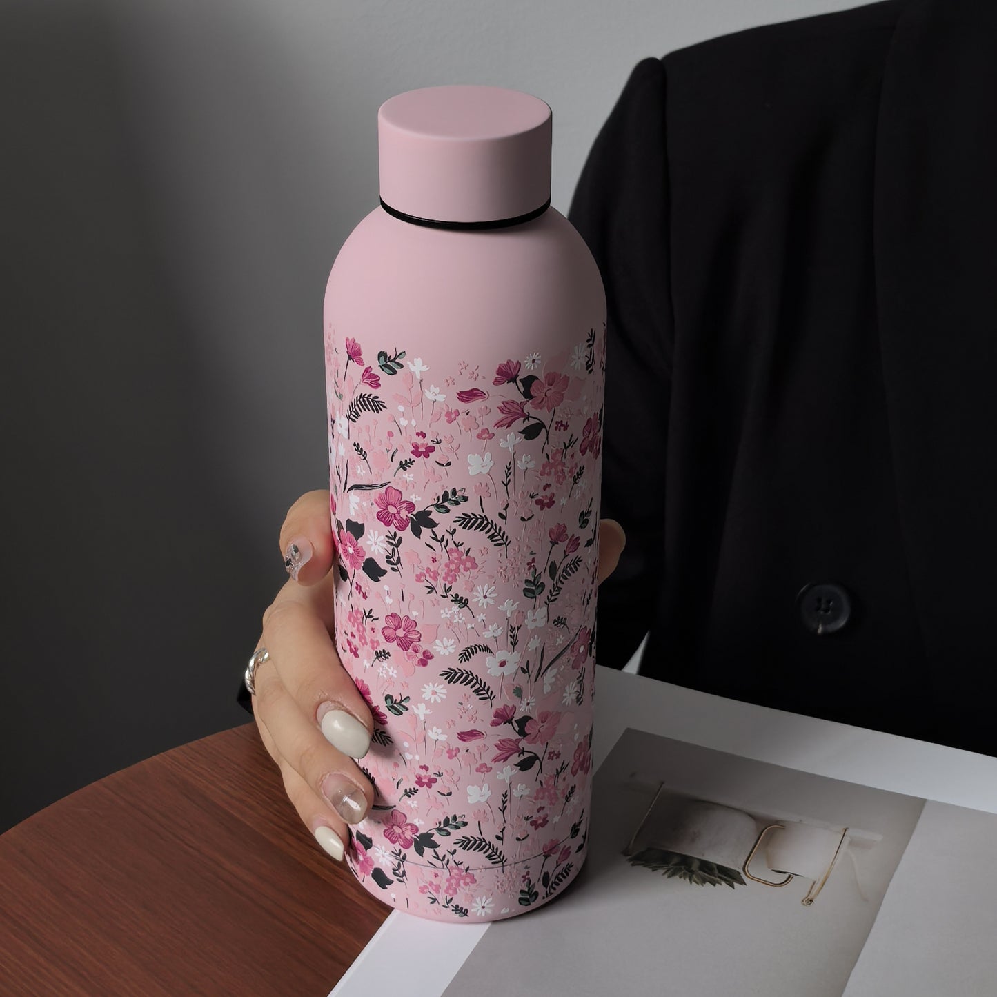 Stylish 16.9oz insulated water bottle with chic pink floral design, perfect for travel, sports, and everyday use. Great gift for birthdays and holidays.