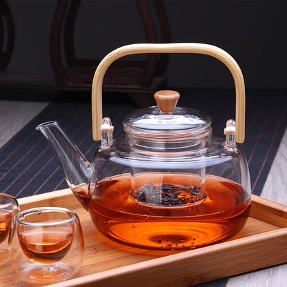 Stylish glass teapot with bamboo handle, ideal for blooming and loose leaf tea. Heat resistant and includes tea infuser. Perfect Christmas gift.