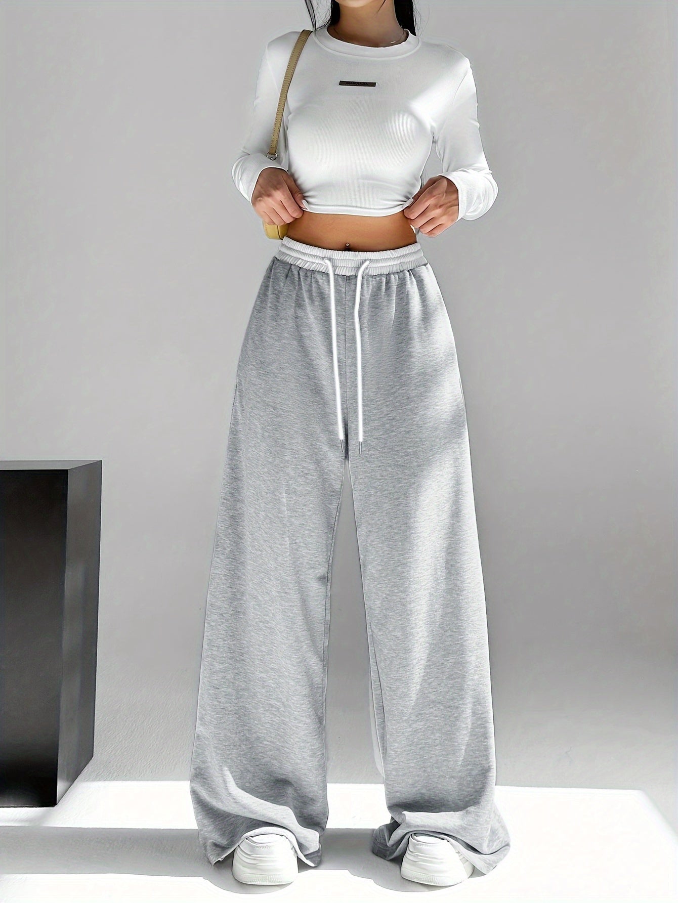 High waist wide leg drawstring pants in contrasting colors for women's spring and fall attire.