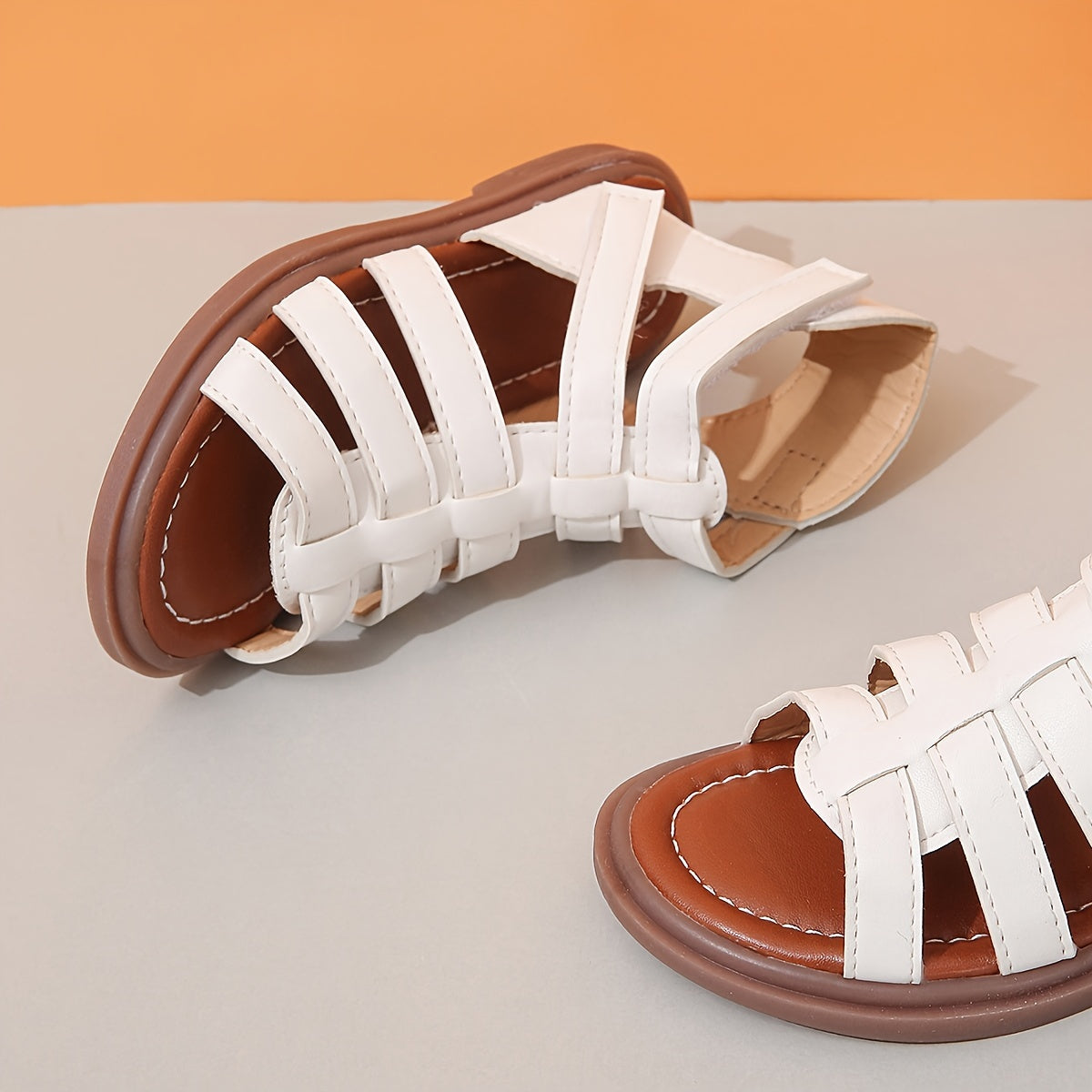 Ivory sandals for girls with brown sole, ideal for school and leisure activities.