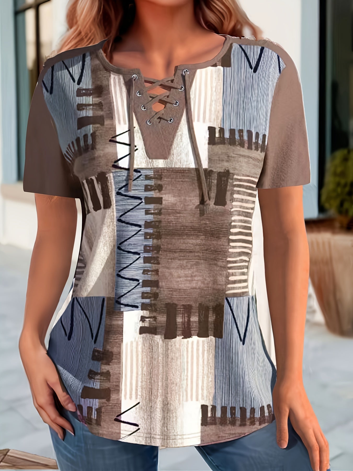 Women's casual geometric print t-shirt with lace-up detail features a v-neck, short sleeves, and stretchy polyester blend. Machine washable.