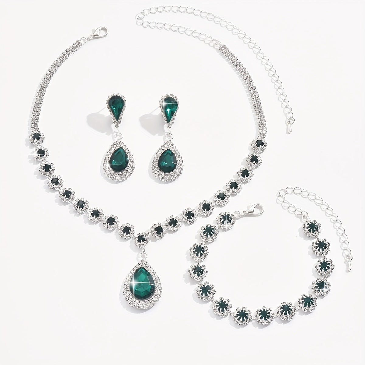 A set of three jewelry pieces for brides and ladies, including one necklace, one pair of earrings, and one bracelet, all featuring flower drop designs. Perfect accessories to complement any dress.