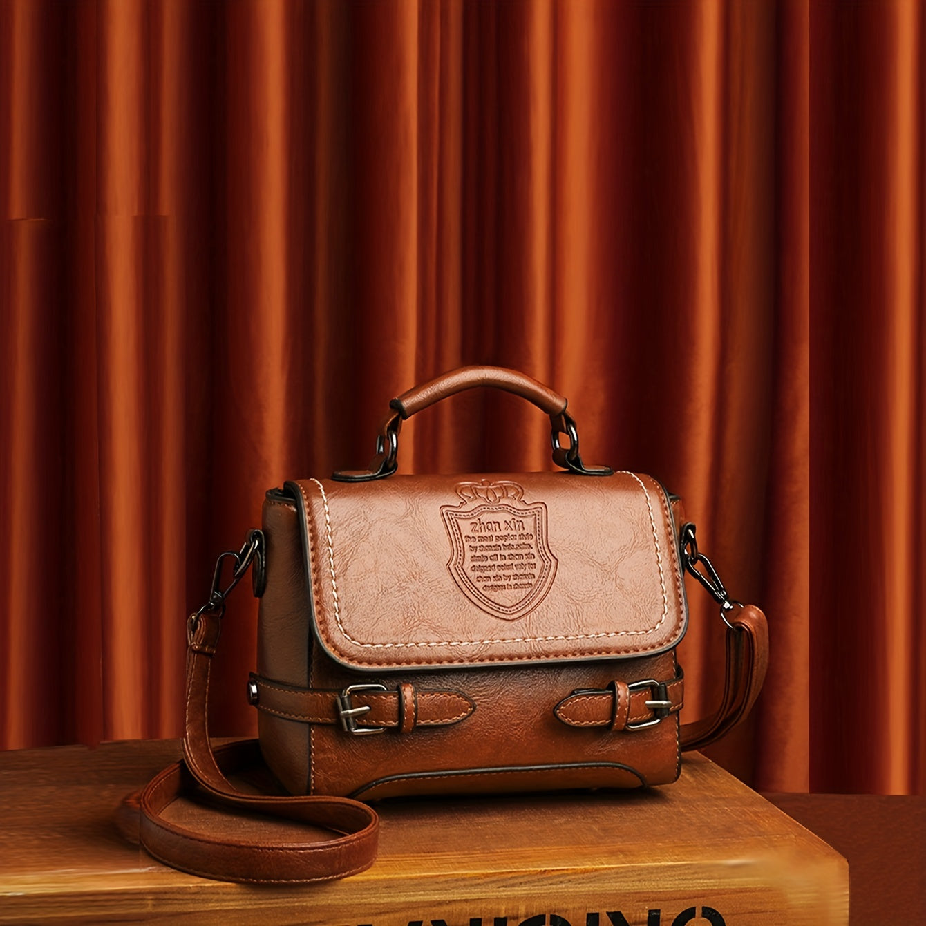 Old-fashioned handbag with embossed letter badge, stylish crossbody satchel for women.