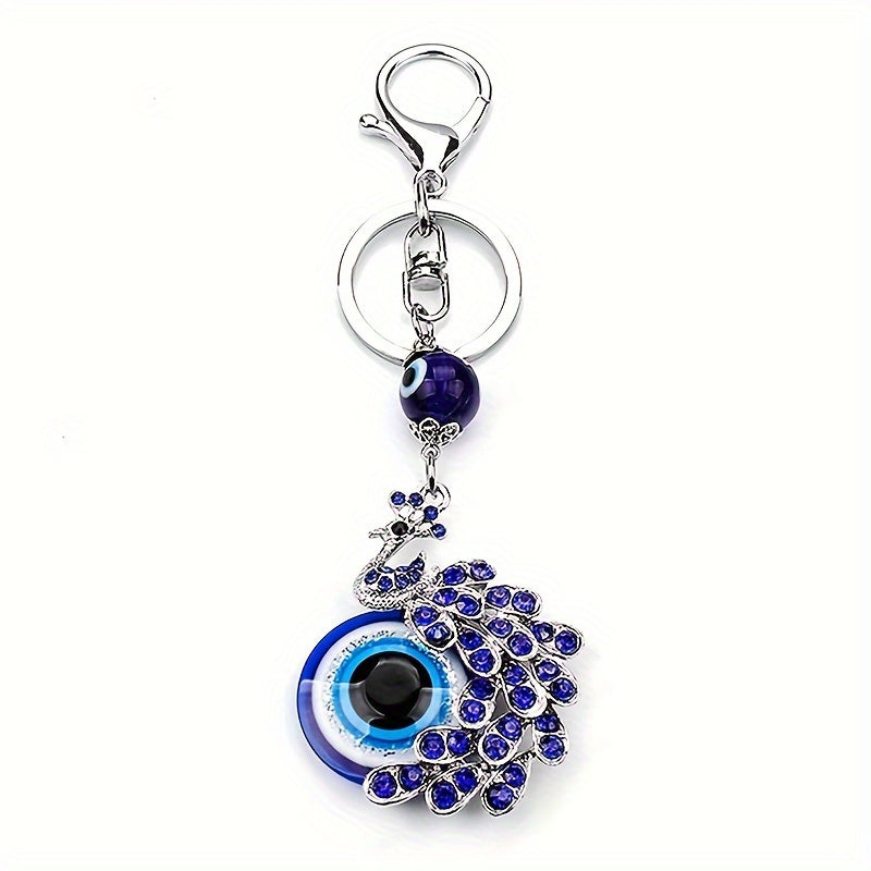 Blue Evil Eye Keychain with Rhinestone Inlaid Peacock Design, made from Alloy, Perfect for Women's Daily Use as a Trendy Hanging Pendant or Bag Charm.