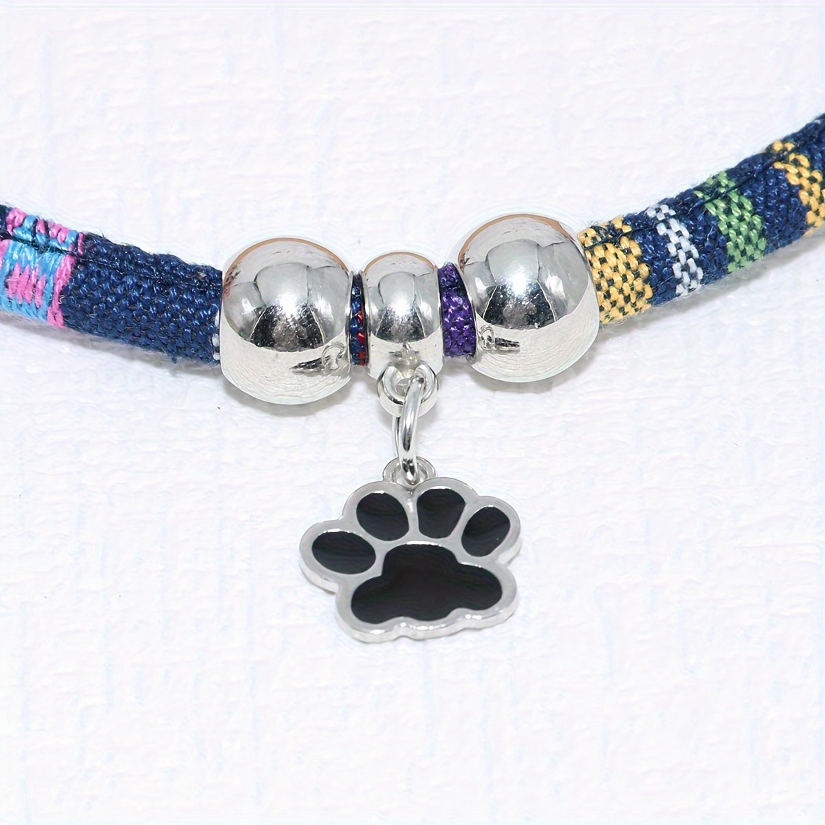 Durable, stylish, adjustable nylon pet necklace with colorful paw print pendant. Suitable for cats and small dogs.