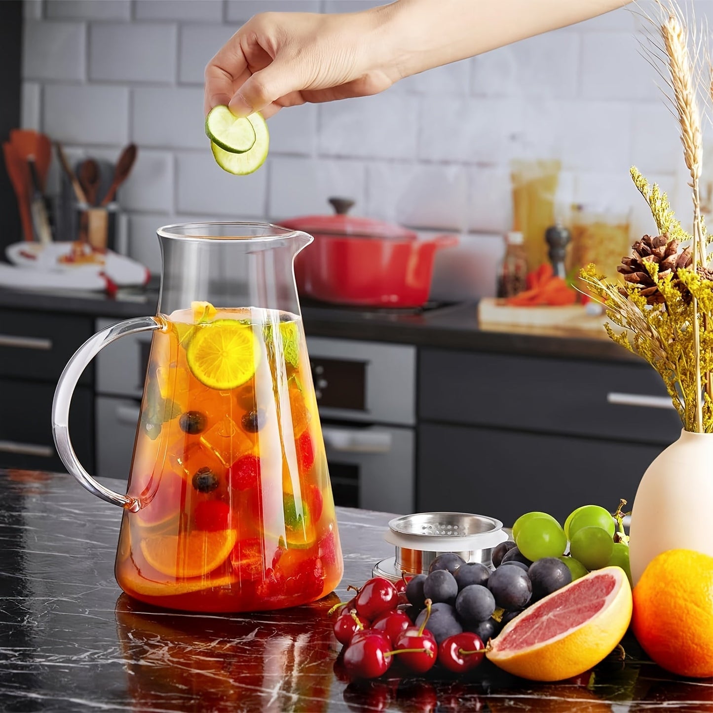 Heat resistant glass pitcher with lid, perfect for hot/cold drinks. Featuring a 1.8L clear beverage carafe with handle for easy serving. Ideal for home, restaurant, or office use. Easy to clean and makes a great gift for Christmas or New Year. A