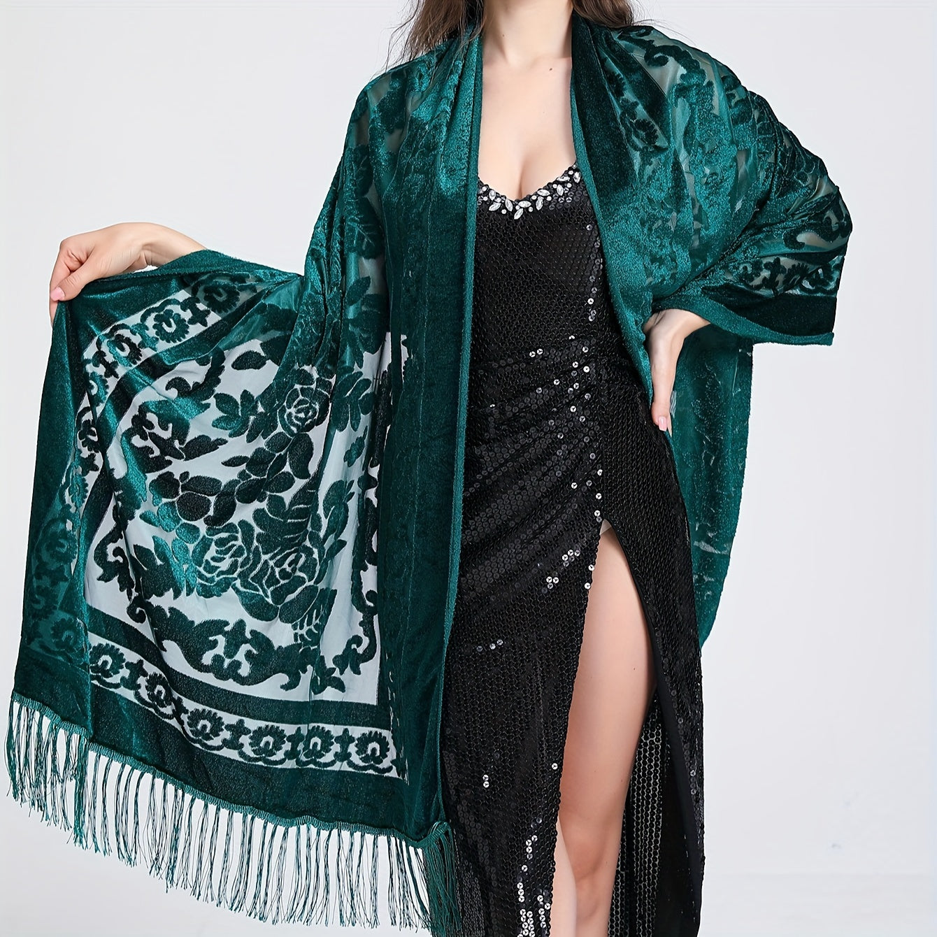 Black floral lace shawl with tassels featuring an elegant rose pattern, 3D carved design, and made of hand washable polyester. Perfect for evening events and dates.