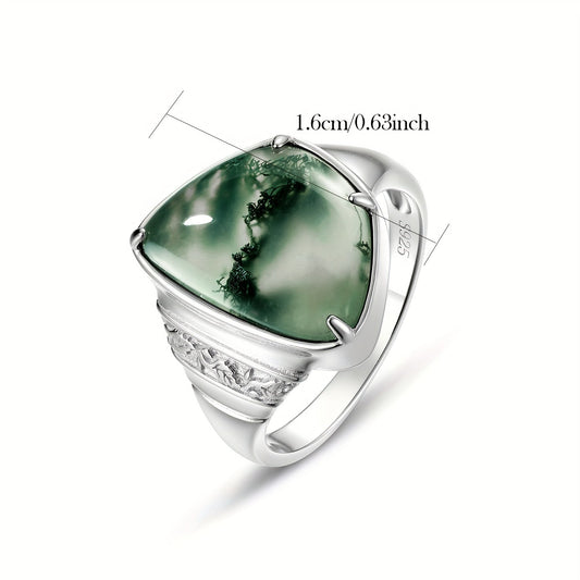 WES presents a stunning Moss Agate ring in a simple Boho style, crafted from S925 Sterling Silver. The ring features a Geometric Irregular shape measuring 10.5*15mm and boasting a 7.5ct Natural Stone. It makes for a fashionable Vintage Wedding