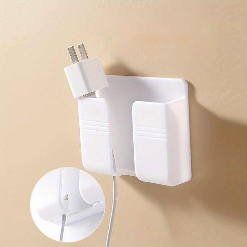 Wall-mounted mobile phone charging stand with storage shelf for organization in bedroom or office.