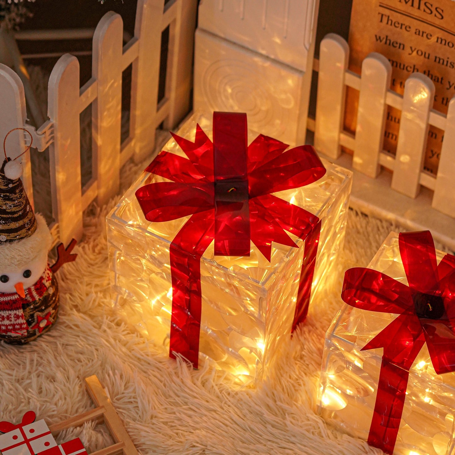 Set of 3 Christmas lighted gift boxes with warm white transparent lights and red bows for outdoor Christmas decorations.