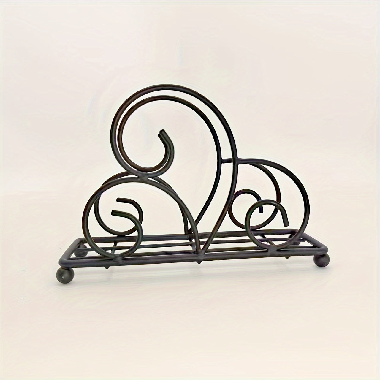 One metal cartoon tree-shaped napkin holder with hollow-out design for kitchen or dining table decoration, made of cast iron.