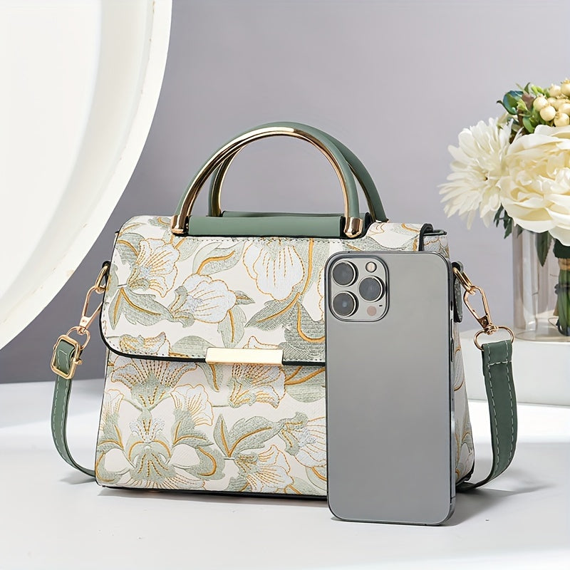 Large capacity floral embroidered crossbody bag with zipper closure and polyester lining. Versatile commuter handbag with luxurious, fashionable design and edge paint detail. Available in