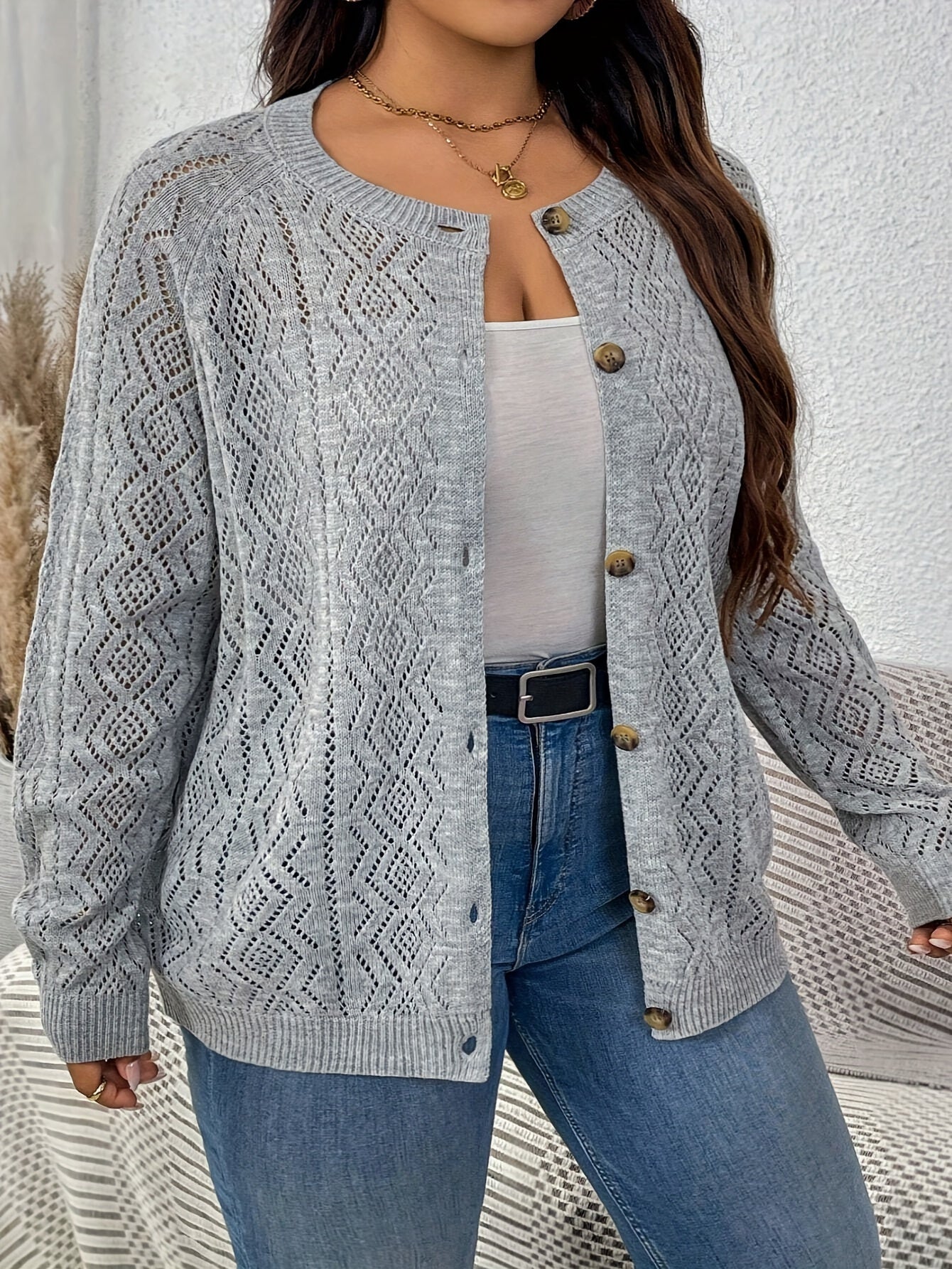 Plus size cable knit cardigan with button front, perfect for fall and winter.