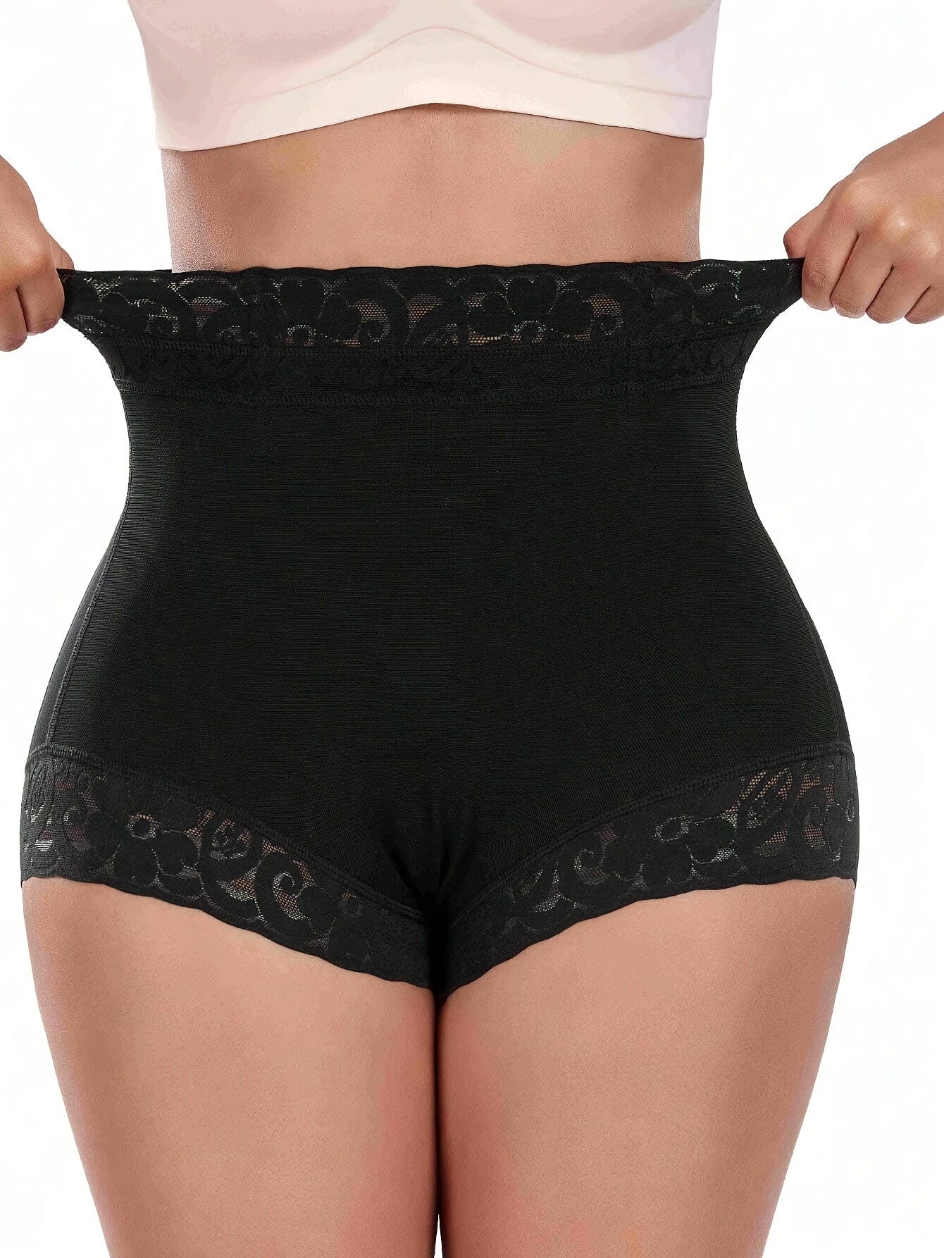 High-waist black shaping shorts with lace detail for tummy control and butt lifting. Made of stretchy nylon and elastane blend. Hand washable with smooth finish. Mid-thigh length and high