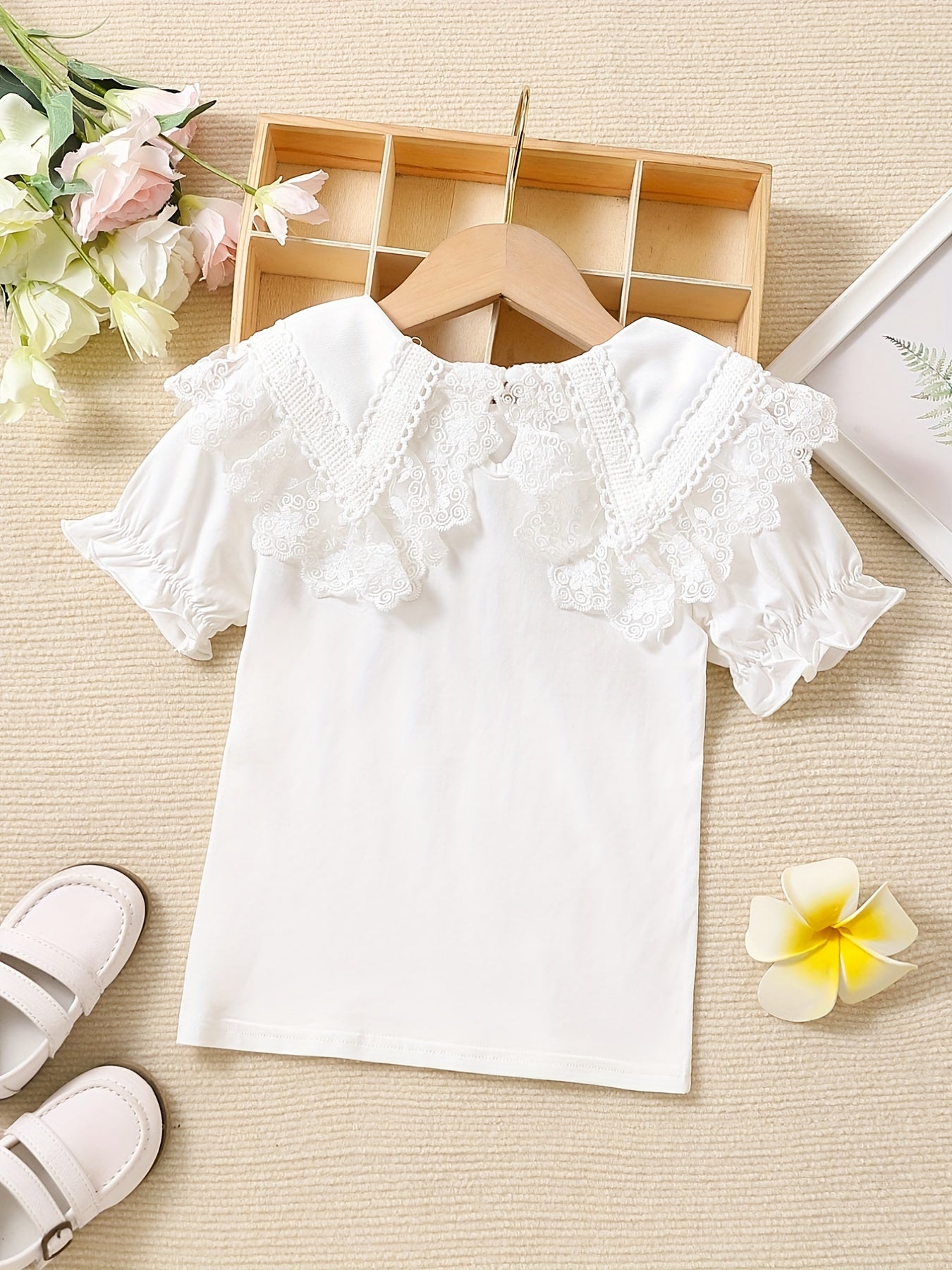 Girls' cotton knit T-shirt with lace collar detail, ideal for summer. Stretchy, breathable, and machine washable.