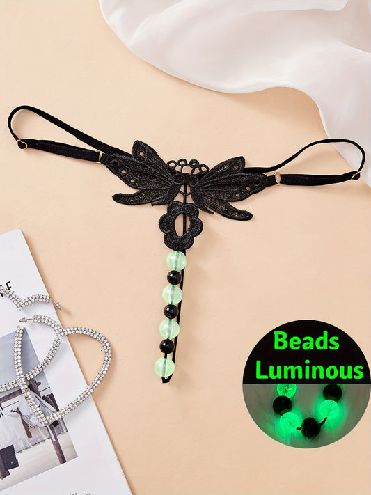 Glowing bead black lace thong, drop waist V-string with massage beads for women. Part of our adult elegant collection.