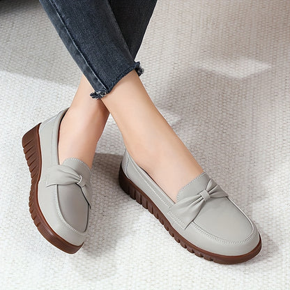 Women's comfortable penny loafers with bow embellishment, non-slip sole, round toe, all-season footwear, man-made materials, TPR sole.