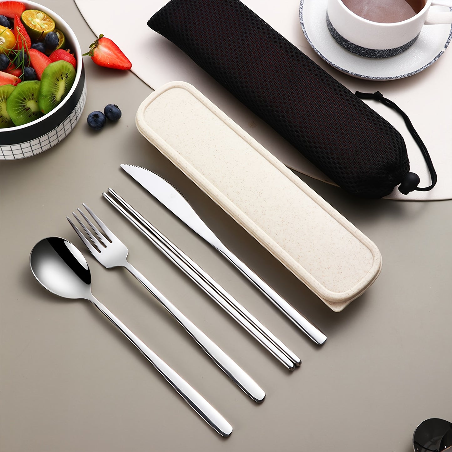 Stainless steel cutlery set includes knife, fork, spoon, and chopsticks in portable case for picnics, camping, lunches, and gatherings.