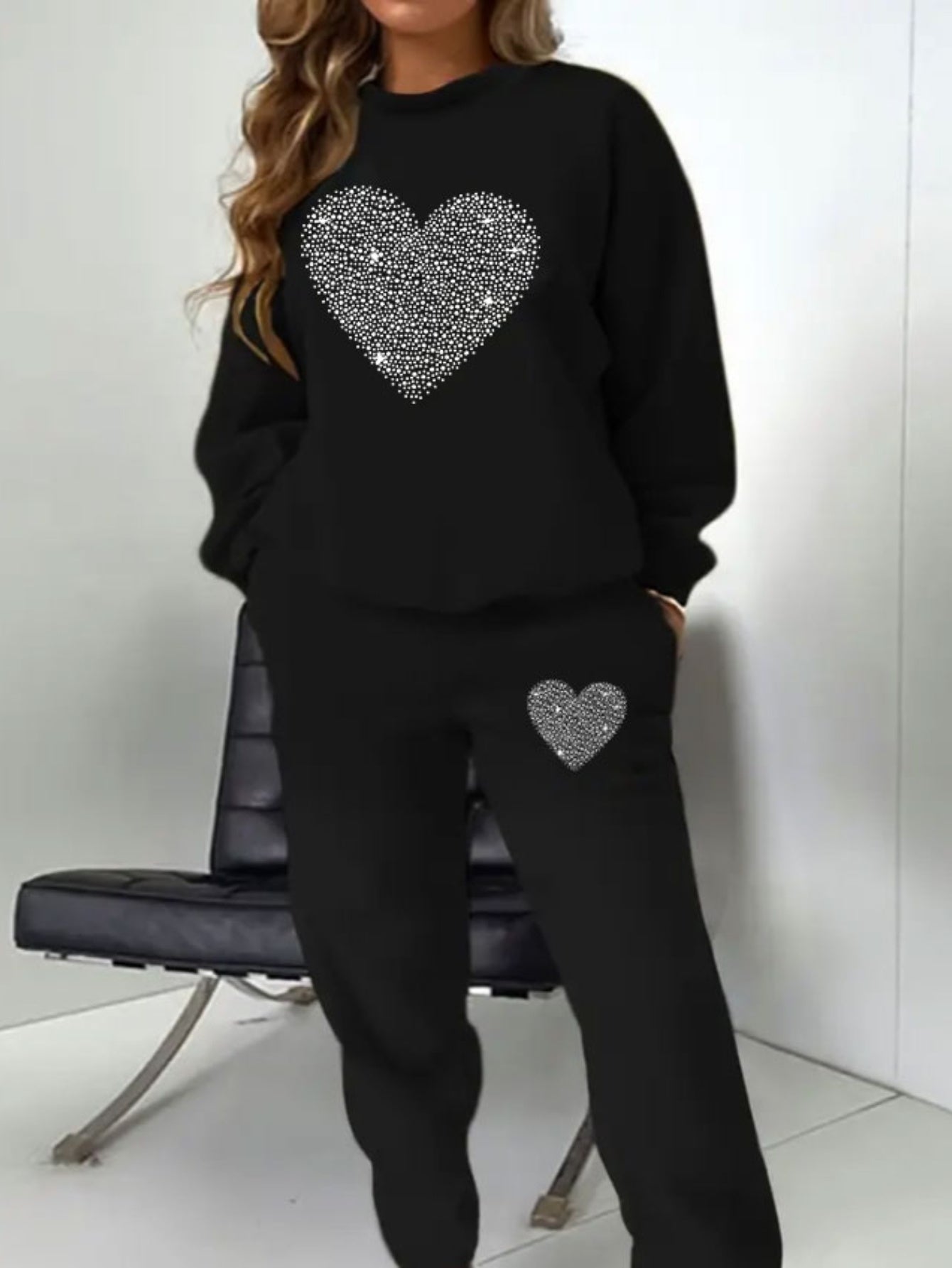 Plus-size women's sweatshirt and joggers set with heart print, crew neck, and pockets. Machine washable.