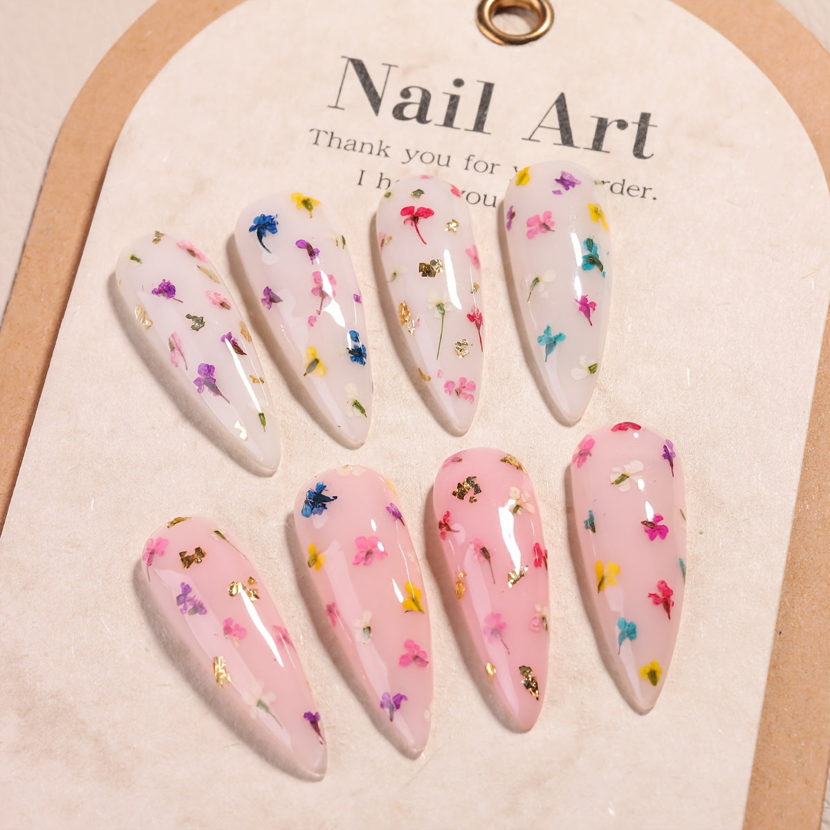 1 bottle of unscented metal compatible soak-off gel nail polish with dried flower design in colors of pink, red, yellow, and blue. Ideal for DIY manicures and nail art.