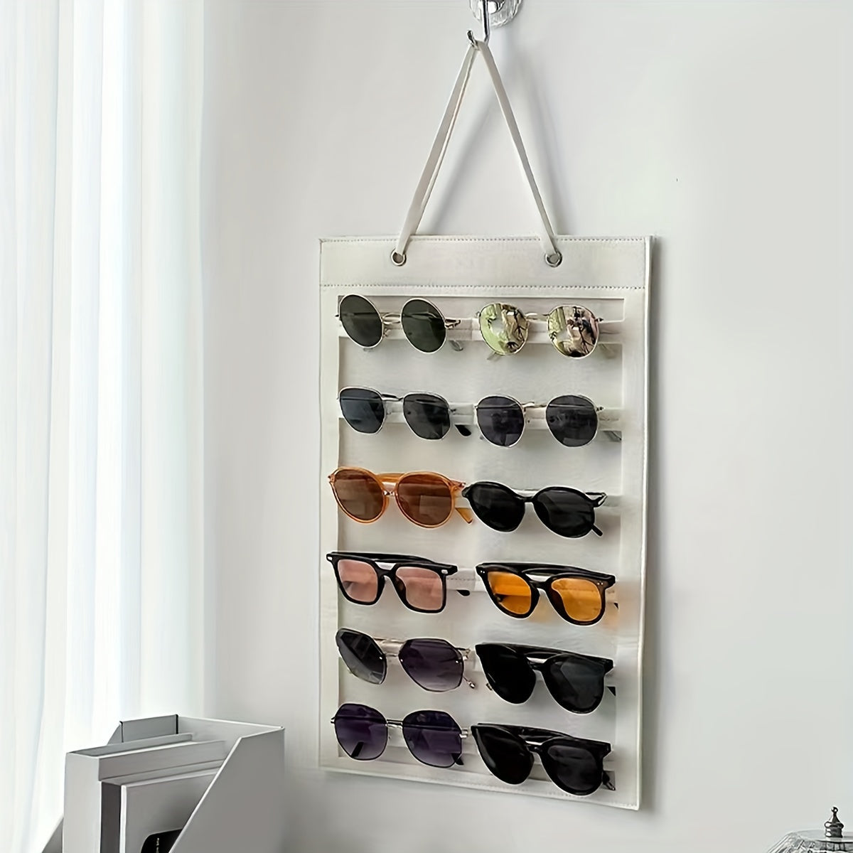 Organize your sunglasses with this hanging wall organizer featuring 12 slots made of felt. Keep your glasses dust-proof and easily accessible with this storage display pocket wall stand holder.