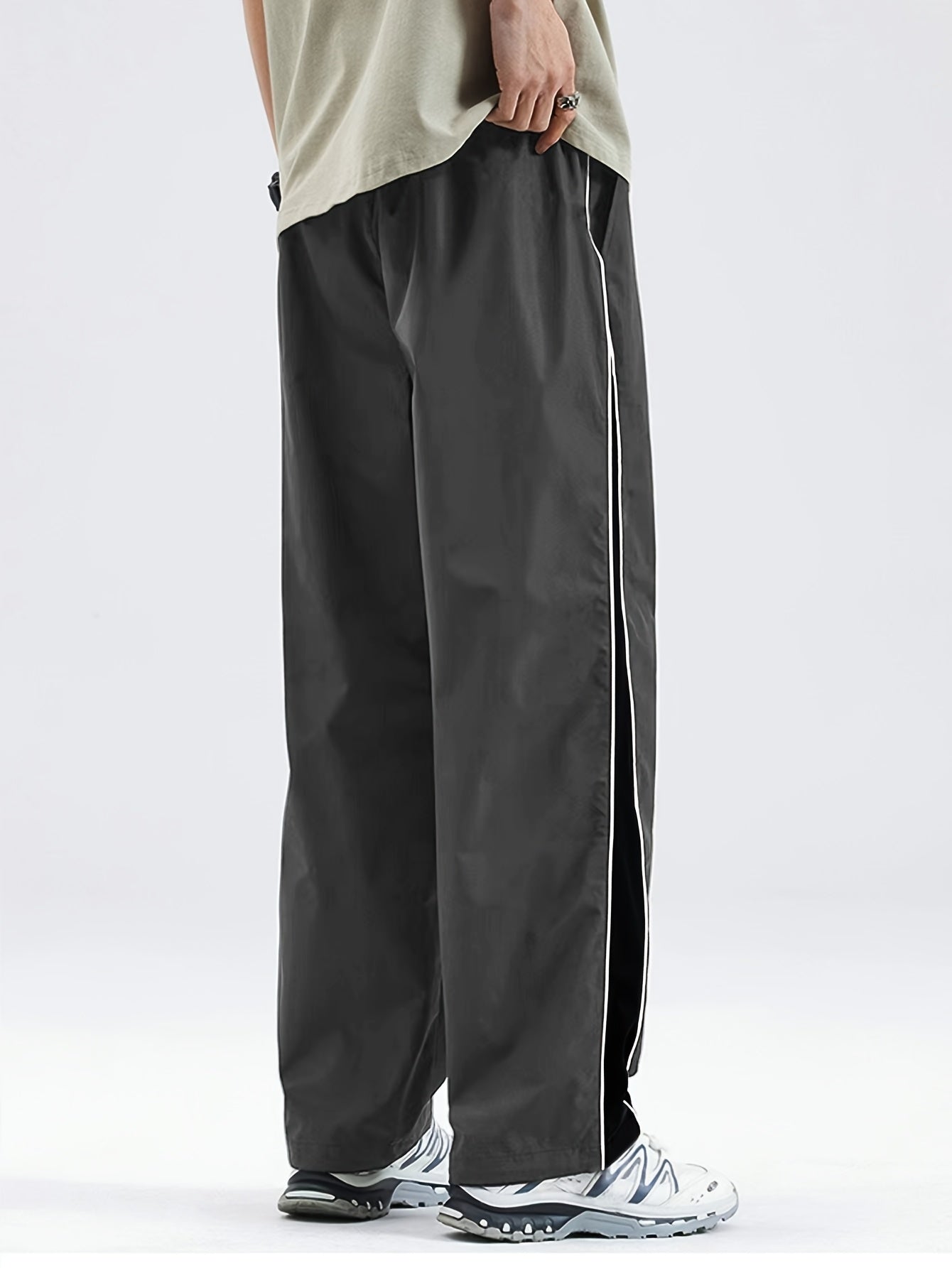 Men's black lightweight joggers with drawstring waist, perfect for spring and fall. Made of polyester fabric with a loose fit and glossy finish.