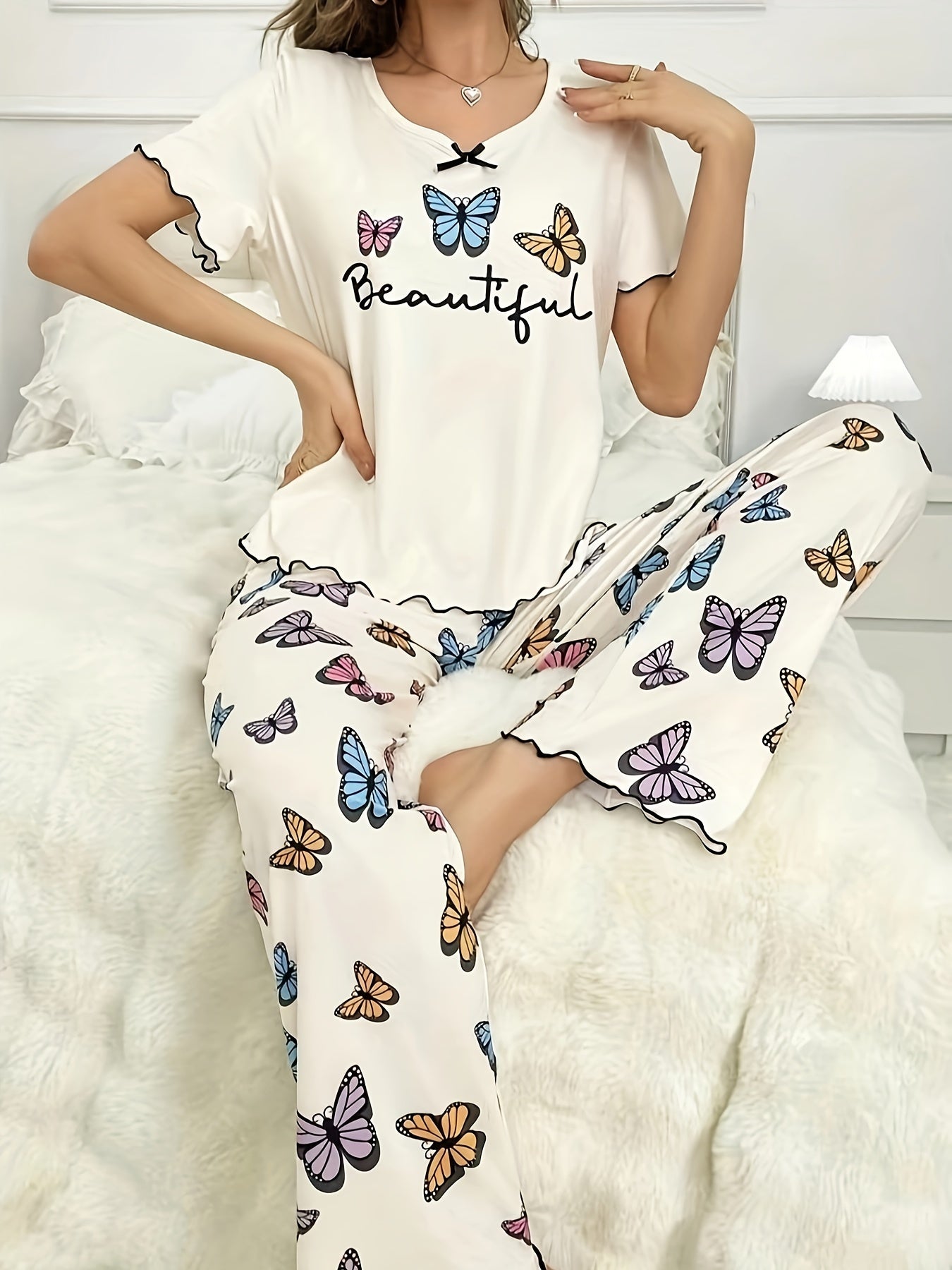 Women's casual lounge set with butterfly and letter print, frill trim, short sleeves, round neck top, and matching pants for a comfortable and relaxed fit.